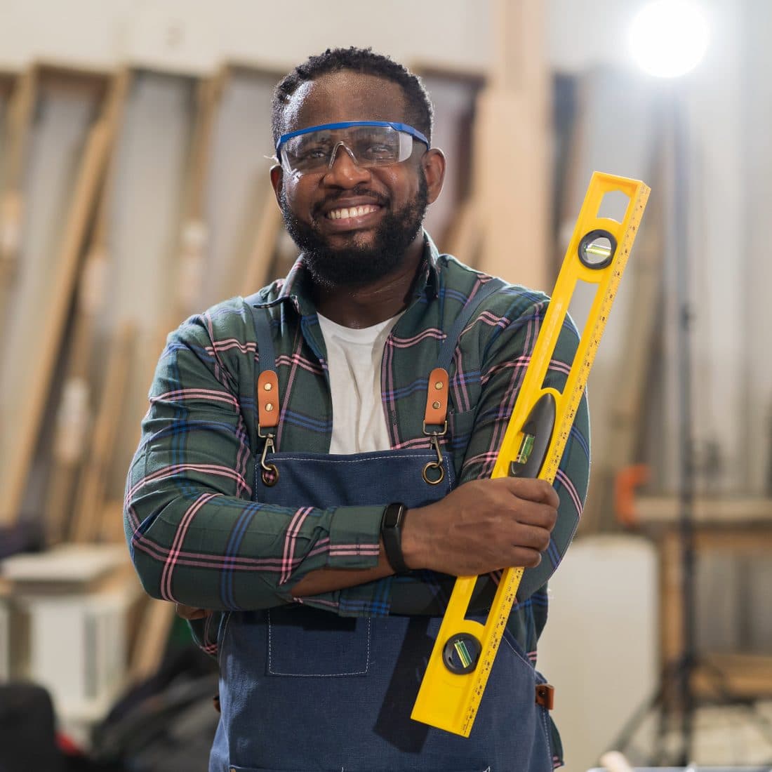 A South African tradesman smiling proudly with his tools